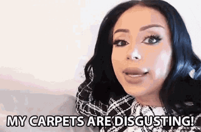 a woman is sitting on a bed and saying `` my carpets are disgusting '' .