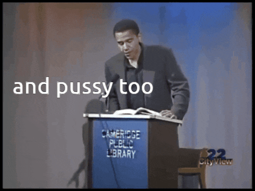 a man stands behind a podium that says cambridge public library on it