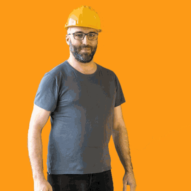 a man with a beard wearing a yellow hard hat