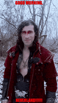 a man in a red coat is standing in the snow with the words " good morning neverland " above him