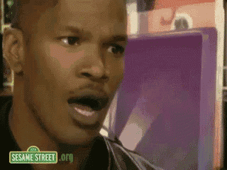 a close up of a man 's face with a sesame street logo behind him