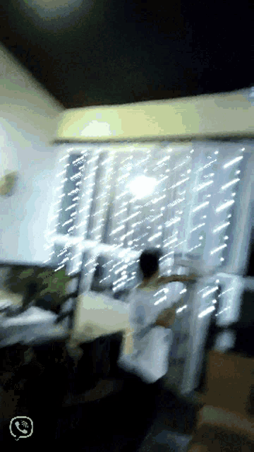 a blurry image of a room with a phone icon