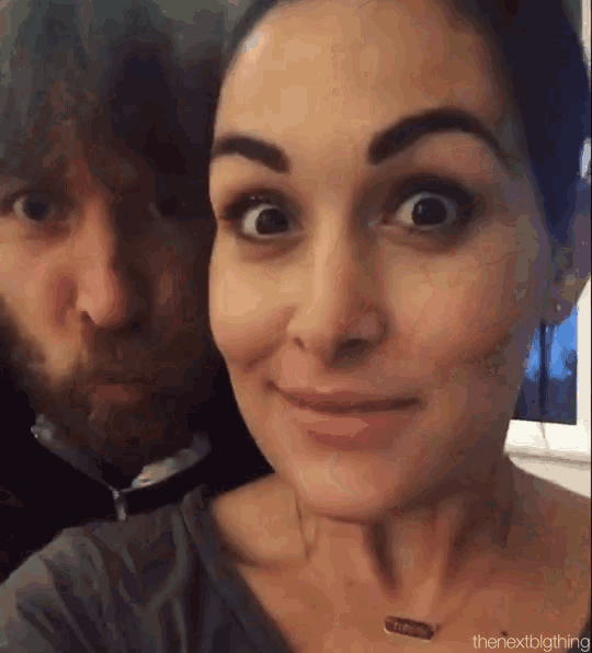 a man and a woman are posing for a selfie and the woman is making a funny face .