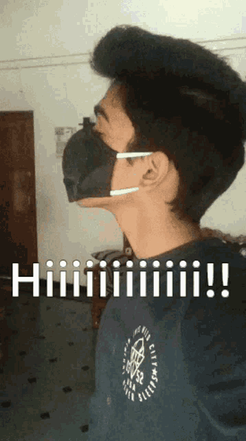 a young man wearing a black face mask with the words hiiiiii written below him