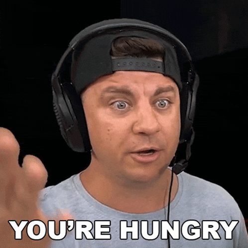 a man wearing headphones and a hat is saying you 're hungry