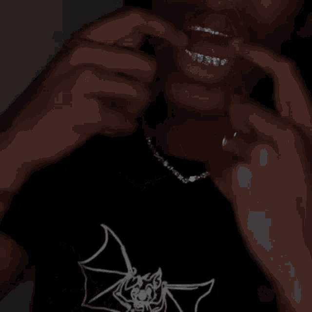 a person with braces on their teeth is wearing a necklace .