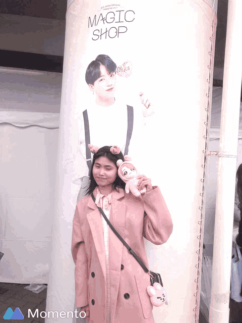 a woman standing in front of a magic shop sign