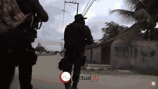 two soldiers are walking down a street with the words actual rj in the corner