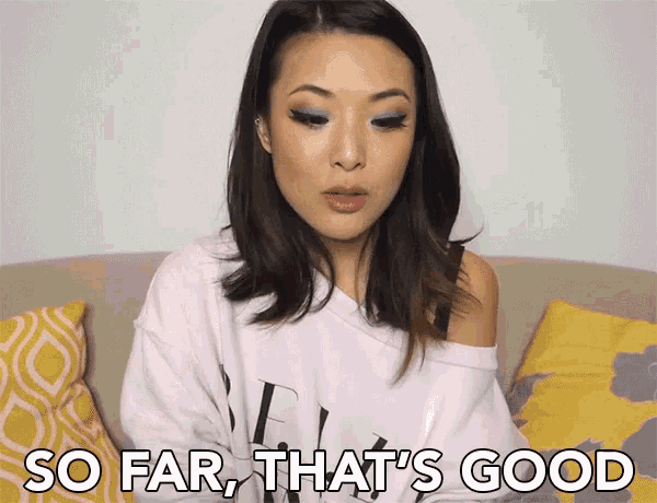 a woman is sitting on a couch with the words so far that 's good behind her