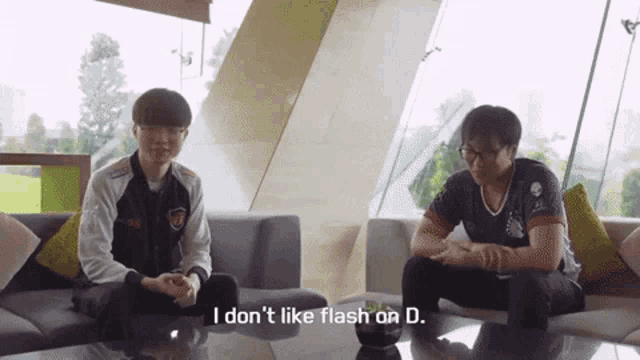 two men are sitting on a couch and one of them is saying " i don 't like flash on d. "
