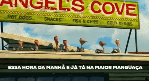 a sign for angels cove hot dogs snacks and fish n chips