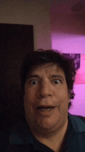 a man with a surprised look on his face is making a funny face .