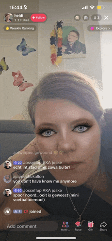 a woman 's face is shown on a phone screen with the time 15:44 on it