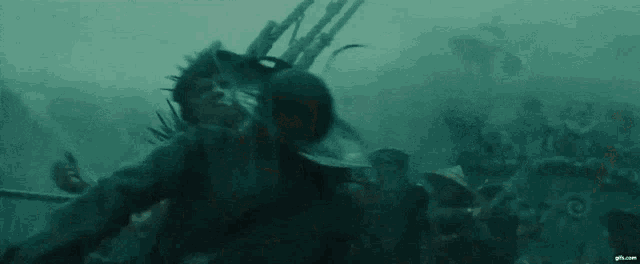 a group of people are swimming in the water .
