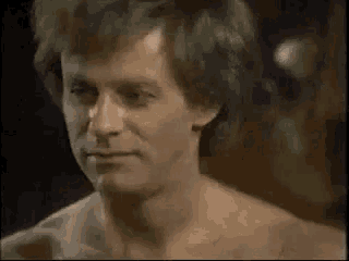 a close up of a shirtless man 's face .