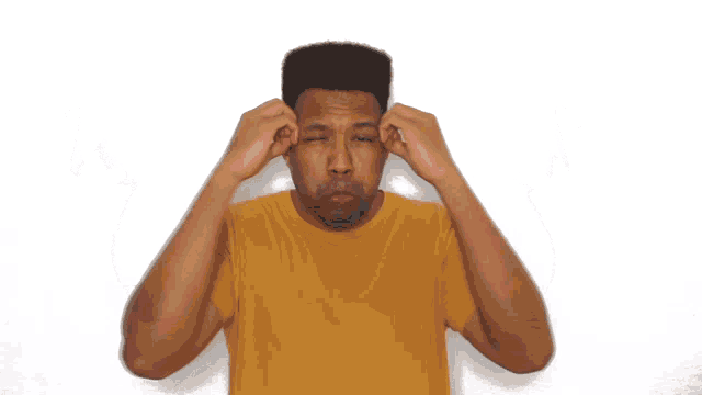 a man wearing a yellow shirt is making a funny face
