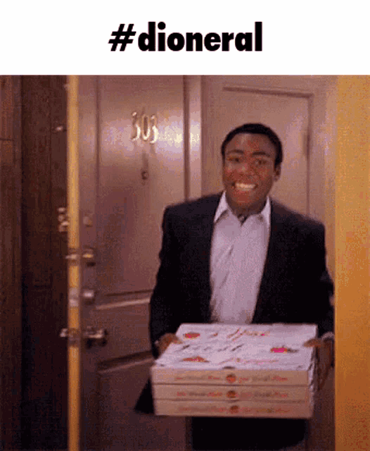 a man in a suit is carrying three boxes of pizza in front of a door with the number 303 on it