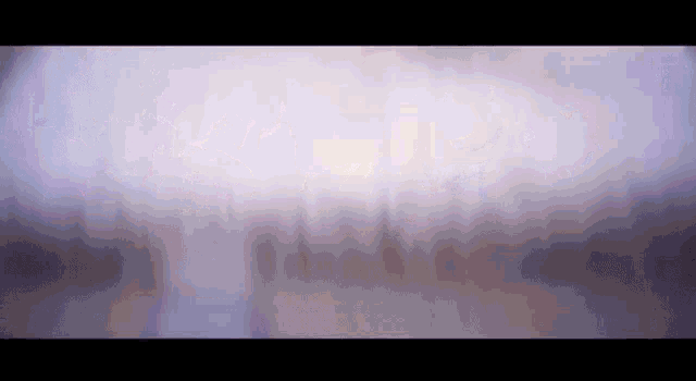 a blurry picture of a purple background with a few lines of light coming out of it .
