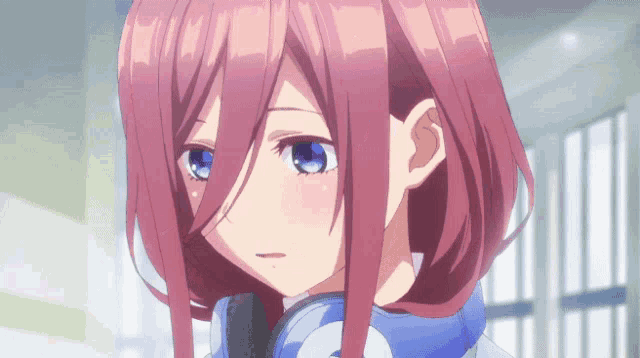 a girl with pink hair and blue eyes is wearing headphones on her neck