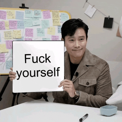 a man holds up a sign that says " fuck yourself "