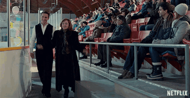a netflix ad shows a man and a woman walking in a stadium