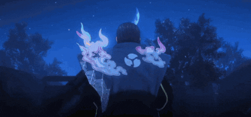 a man is standing in the dark with a glowing feather on his back