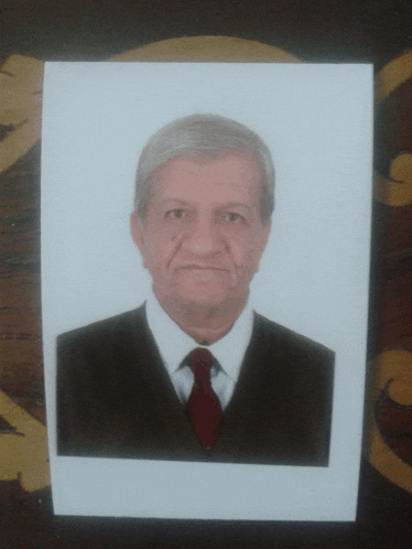 a picture of a man in a suit and tie is on a table