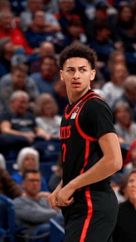 a basketball player wearing a number 2 jersey stands on the court