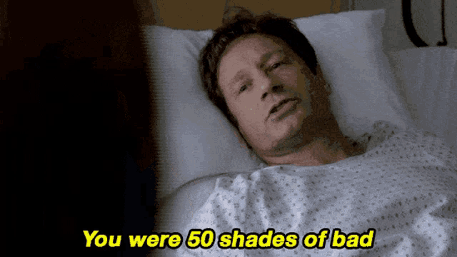 a man laying in a hospital bed with the words you were 50 shades of bad above him