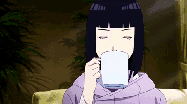 a girl with short black hair is drinking from a white cup