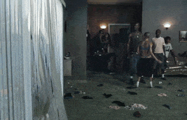 a group of people are standing in a living room