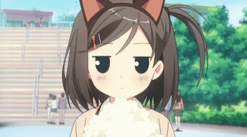 a girl with cat ears on her head is eating rice .