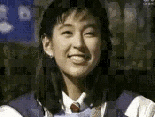 a close up of a woman 's face with a sign in the background that says abc