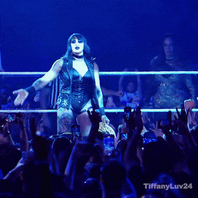 a woman stands in front of a crowd with the words tiffanyluv24 on the bottom right