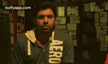a man wearing a blue aeropostale hoodie looks at the camera