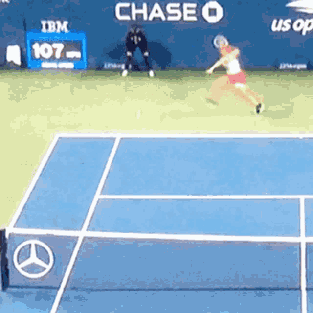a tennis game is being played in front of a chase banner