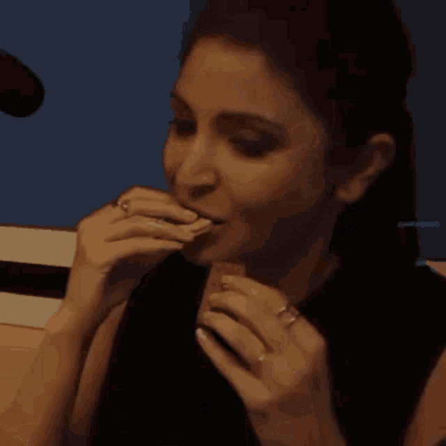 a woman wearing a ring on her finger is covering her mouth