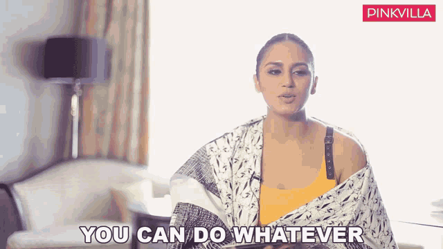 a woman says " you can do whatever " in front of a pinkvilla ad