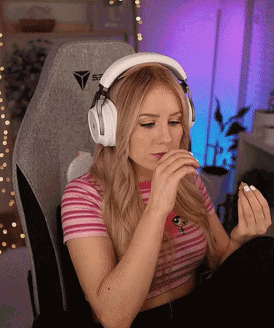 a woman wearing headphones with the letter s7 on the back of her chair