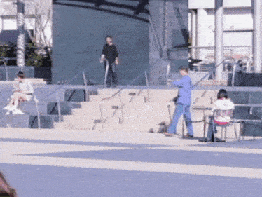 a man in a blue suit is walking down stairs