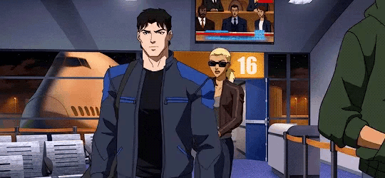 a man in a blue jacket is standing in front of a sign that says 16