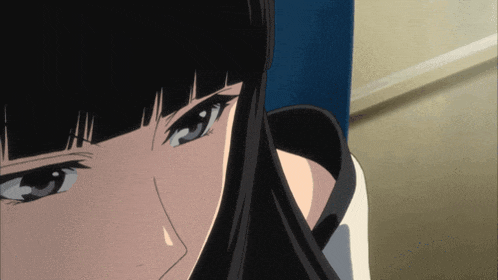 a close up of a girl 's face with black hair and blue eyes
