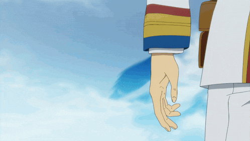 a person 's hand is reaching out towards a blue sky