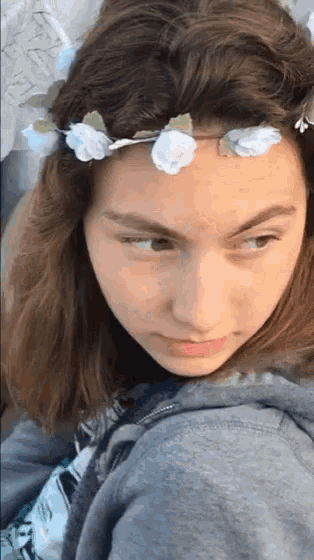 a woman with a flower crown on her head