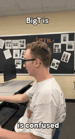 a man sitting in front of a computer with the words bigt is confused above him