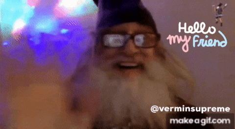 a man with glasses and a beard is smiling with the words hello my friend above him