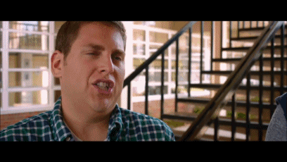 a man in a plaid shirt is making a funny face