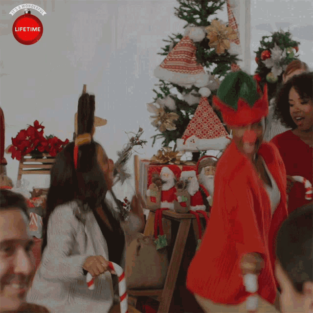 a group of people are celebrating christmas with a lifetime christmas ornament in the background