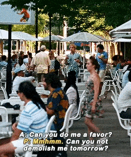 a group of people are sitting at tables and chairs in a restaurant .