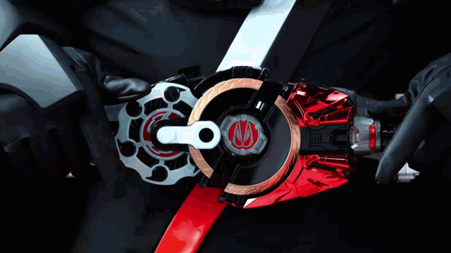 a person is wearing a belt that has a red circle with a s on it